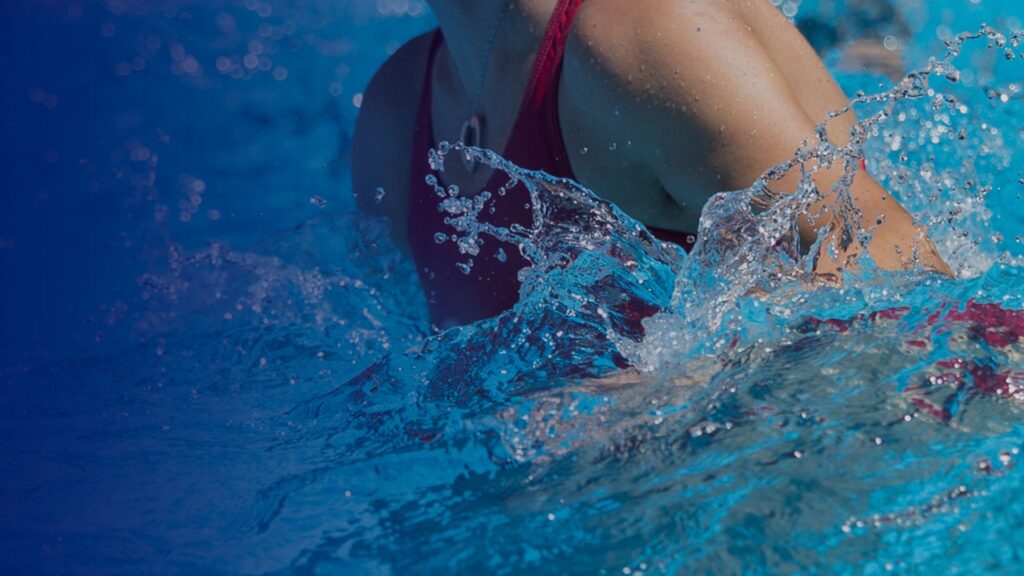 Woman in water creating a splash in Water Workouts